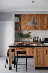 Rustic Kitchen Shaker Cabinets With A White Backsplash And Black Quartz Countertops 200x300 