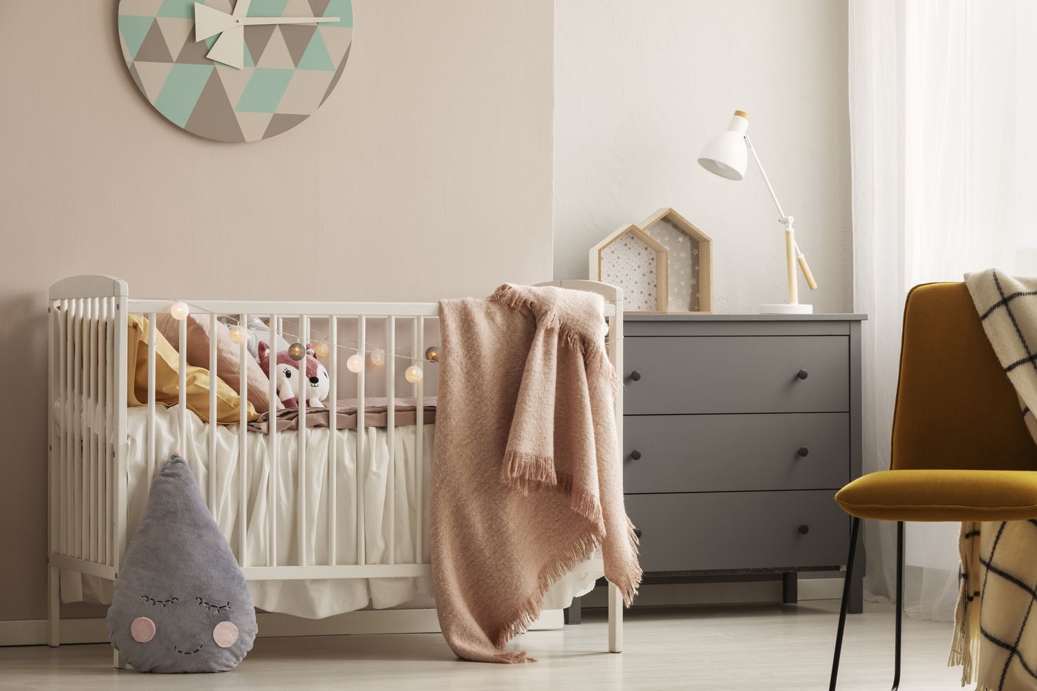 2024 Nursery Colors Guide Trending Palettes Gender Neutral Designs   Pillows And Toy In White Wooden Crib With Pastel Pink Blanket In Bright Nursery 1161220641 0d85ba7b77044b399236ad1ca518947c 